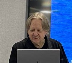 Head and shoulders of Stephen Bell giving a lecture